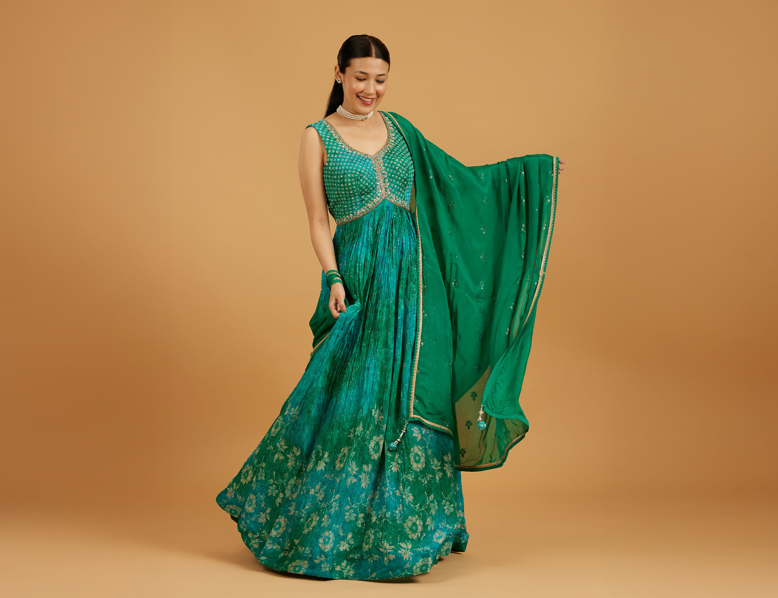 Blue maxi dress styled with traditional Indian accessories for wedding look
